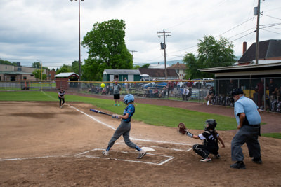 Umpire, catcher, and batter just after batter hit fly ball.