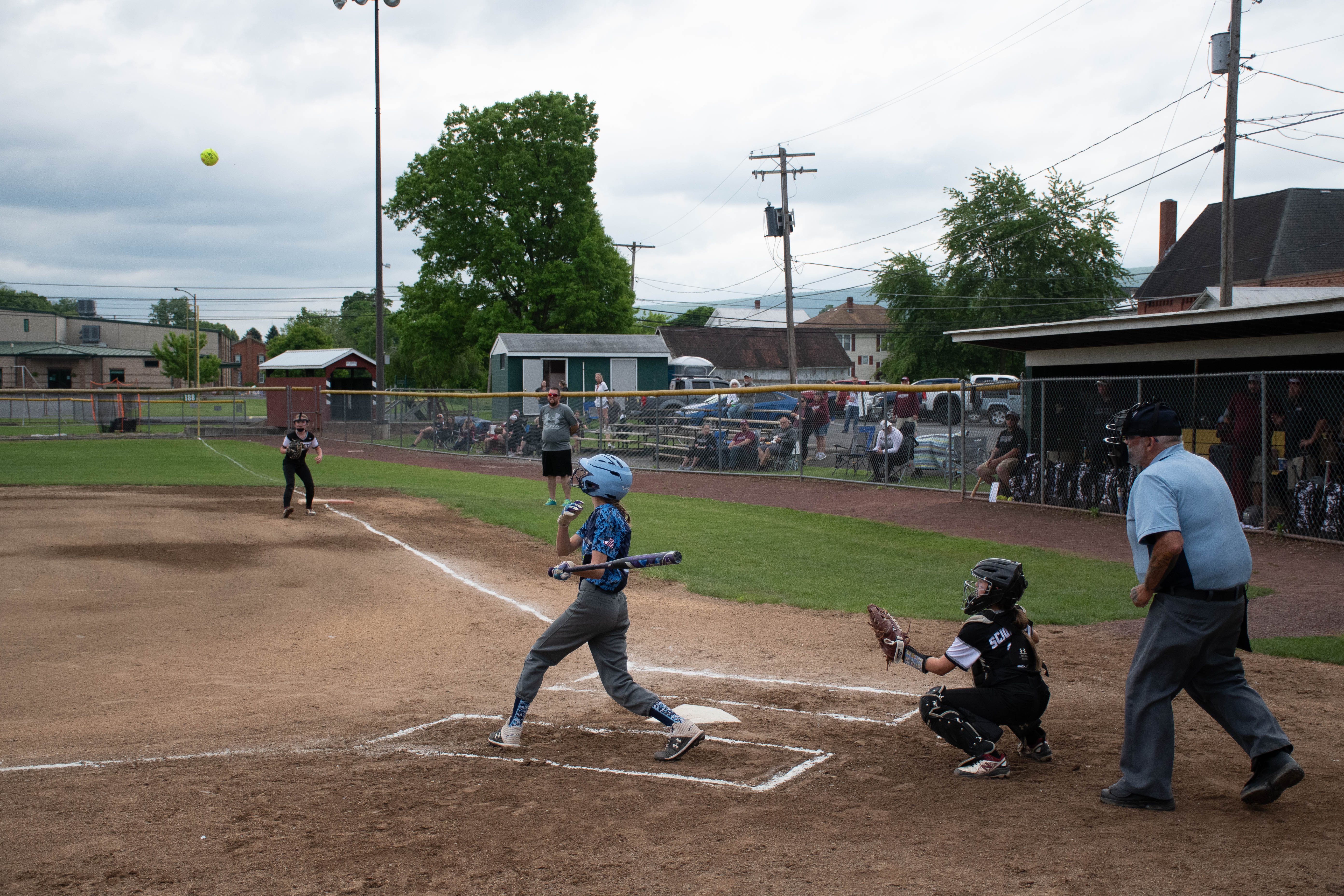 Umpire, catcher, and batter just after batter hit ball.