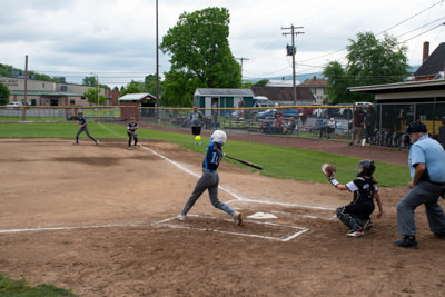 Umpire, catcher, and batter just after batter hit ball.