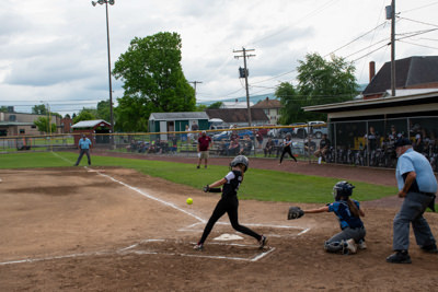 Umpire, catcher, and batter just after batter hit ball.