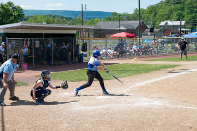 Umpire, catcher, and batter just after batter hits ball.