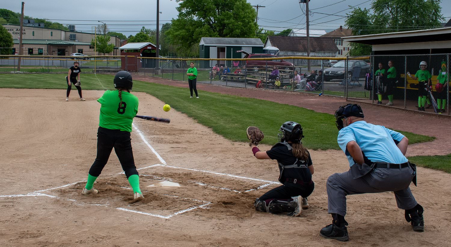 Umpire, catcher, and batter who just hit ball.