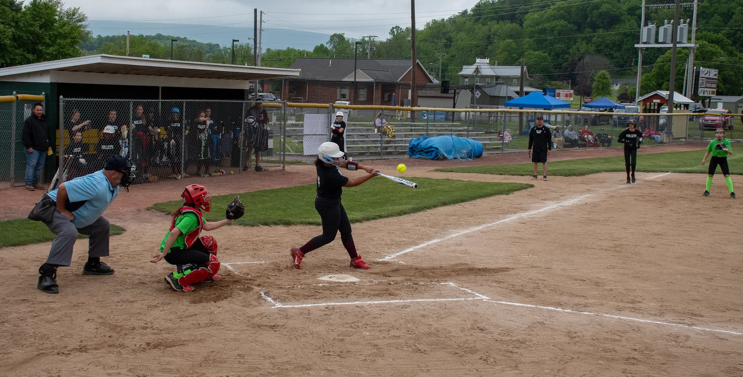 Umpire, catcher and batter as ball is about to contact bat.