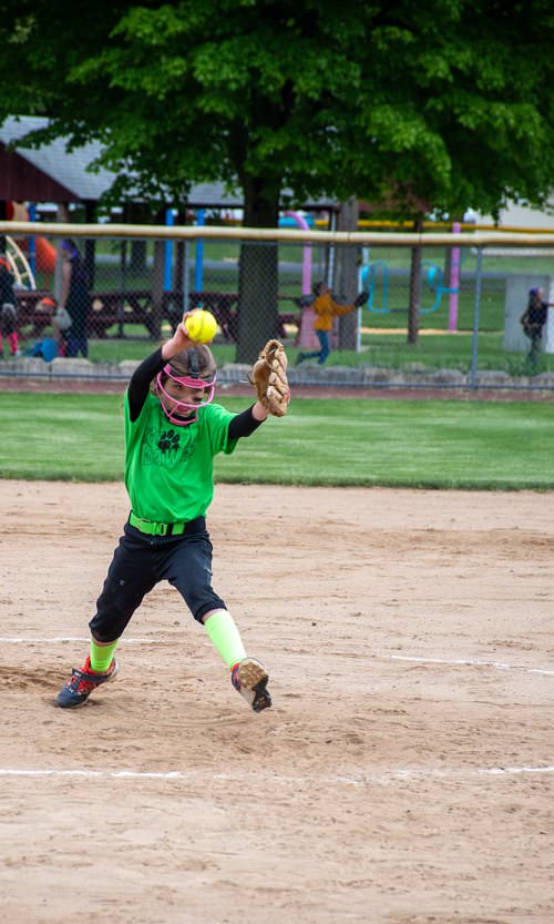 Pitcher in the middle of windup.