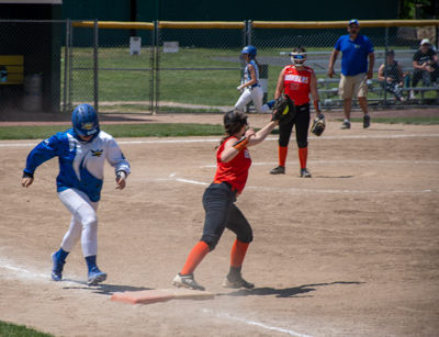 Firstbaseman catches ball just before runner crosses base.