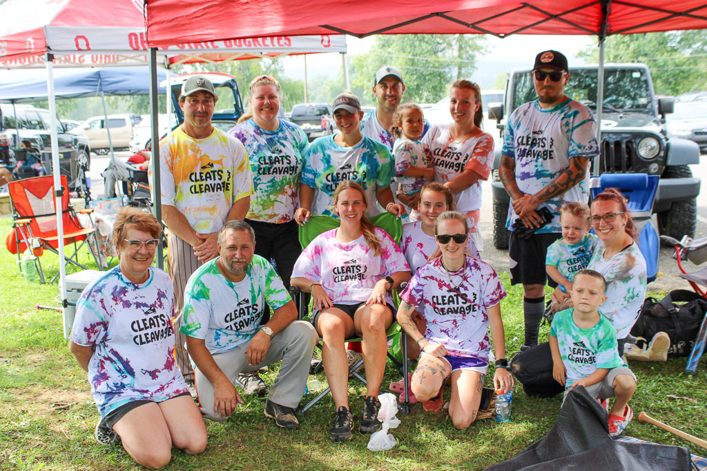 Team Cleats & Cleavage posing together under a tent.