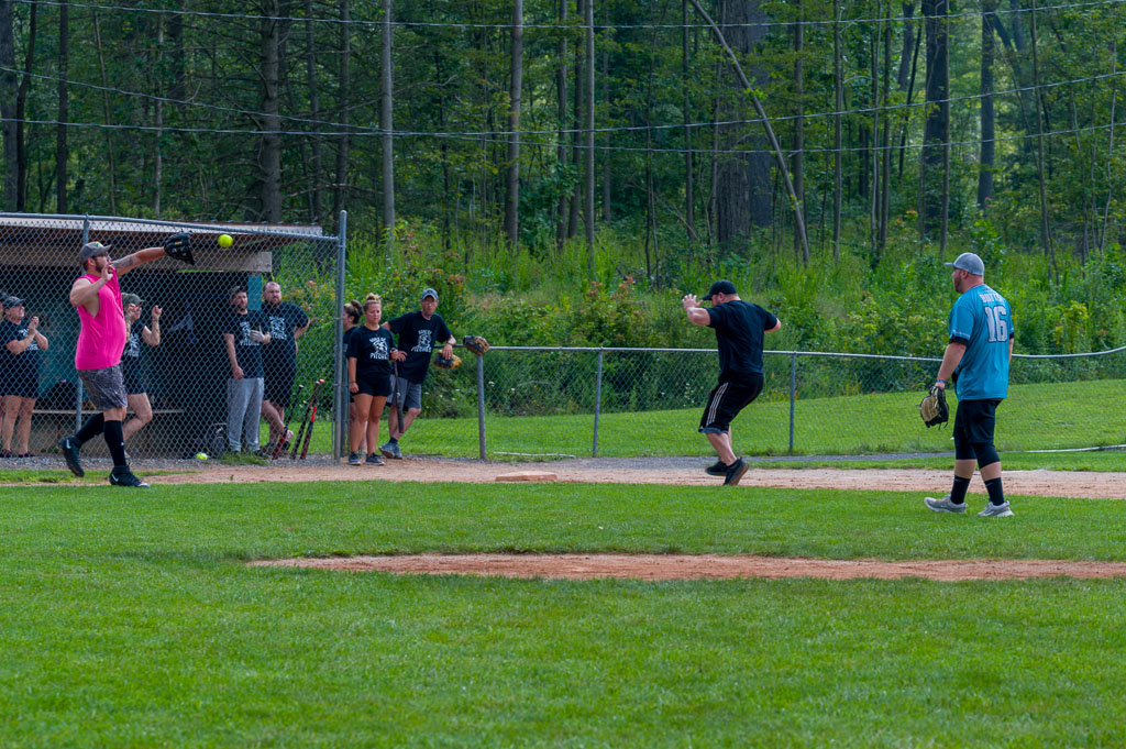 Runner about to cross third base as third baseman catches the ball.