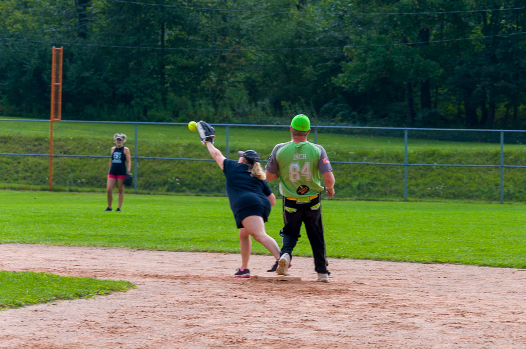 Shortstop catches ball as runner stands on second base.