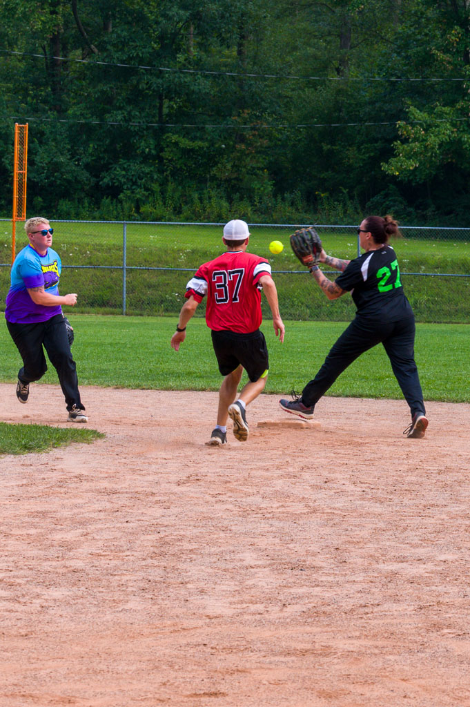 Second baseman catches ball from shortstop as runner approaches second base.