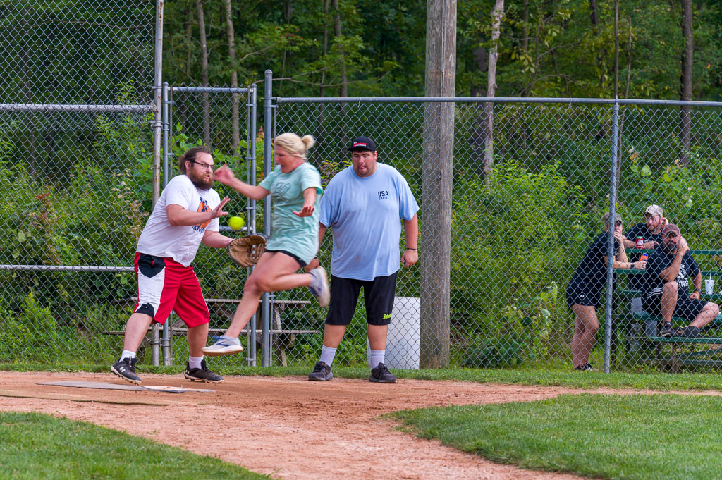 Catcher catches ball as runner hits home plate.