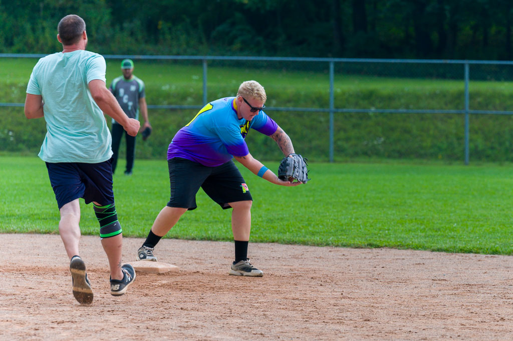 Shortstop catches ball and tags second base as runner approaches.