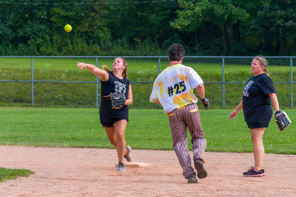 Shortstop throws ball towards first base.