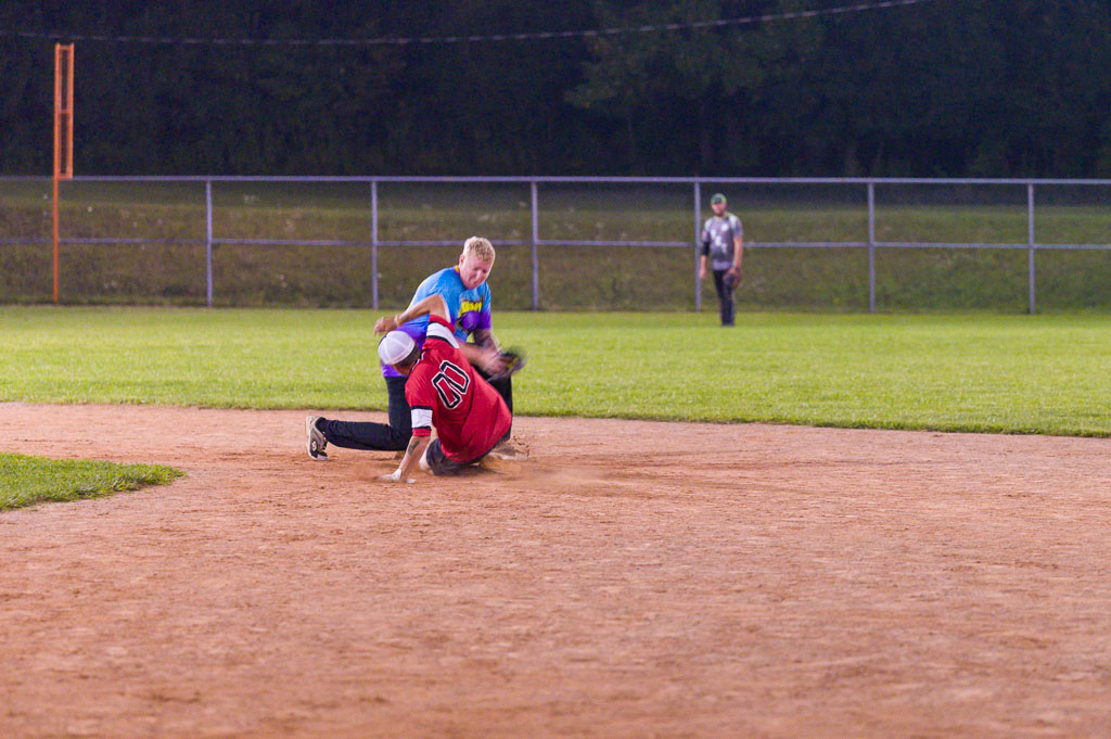 Shortstop with ball as runner slides into second base.