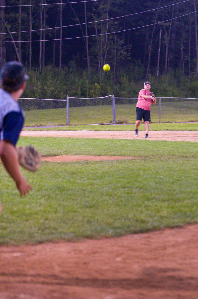 Outfielder throws the ball to first baseman.