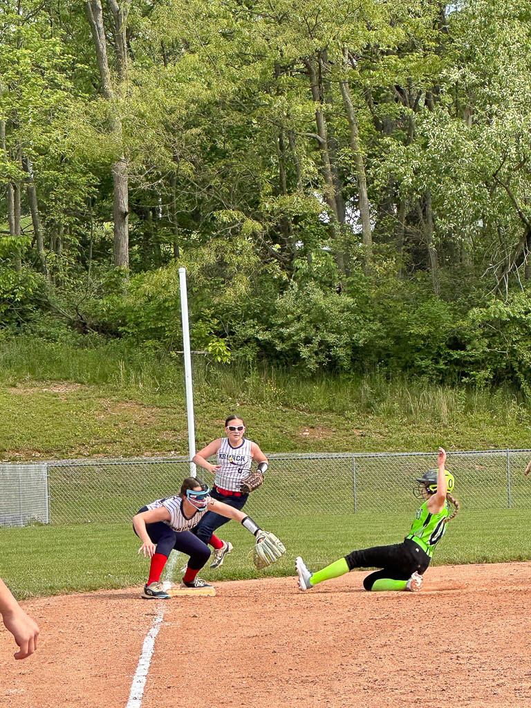 Runner sliding into third base.