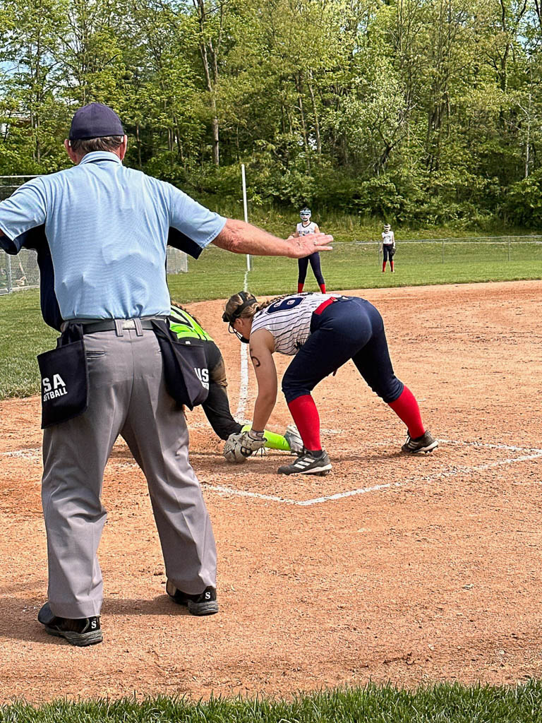 Umpire calling runner safe at home plate.