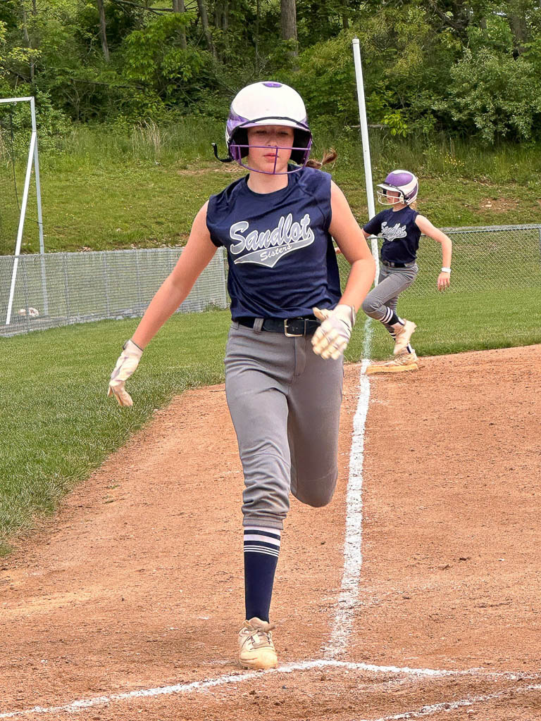 Runner about to cross home plate.