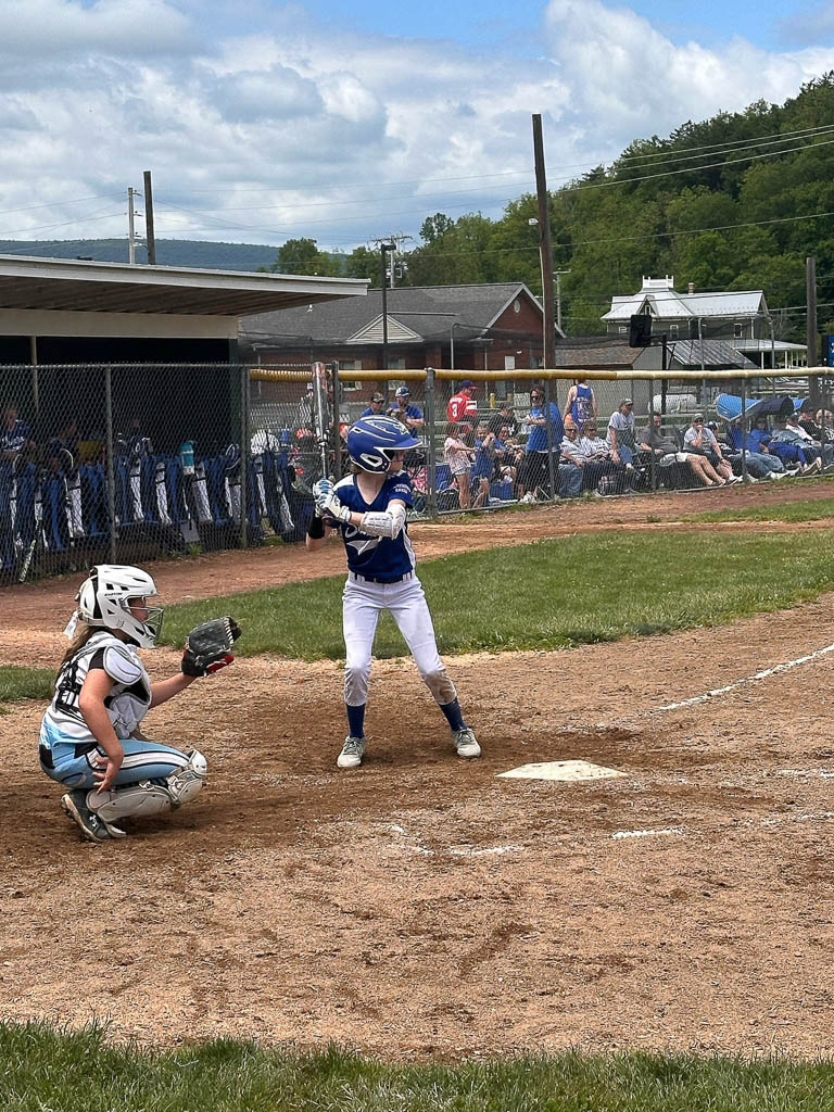 Catcher and batter ready for the pitch.