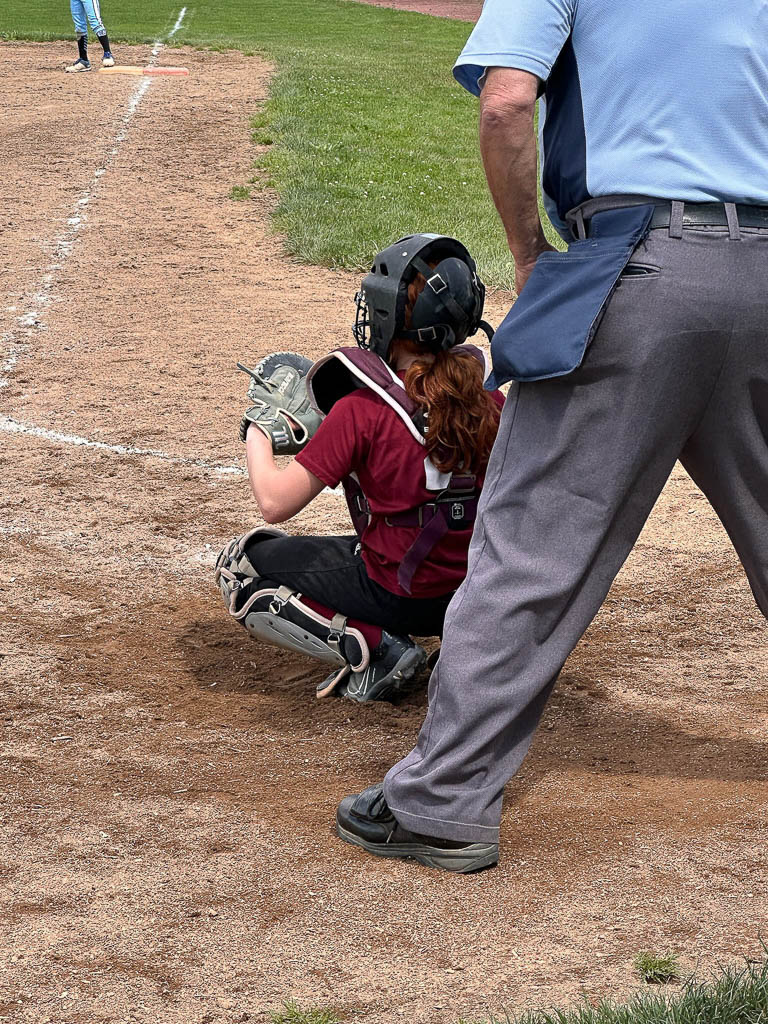 Umpire and catcher are prepared for the pitch.