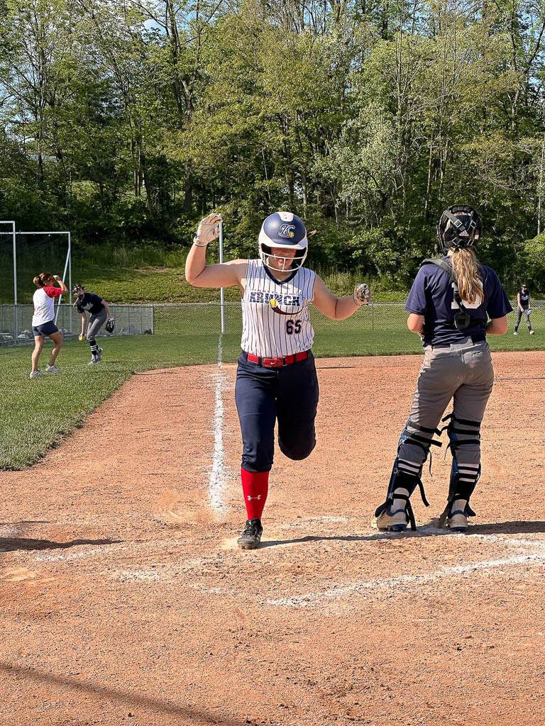 Runner crosses home plate.