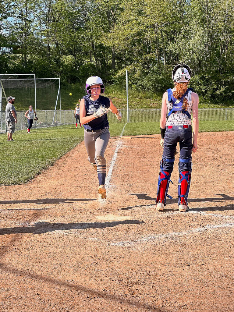 Runner crosses home plate.