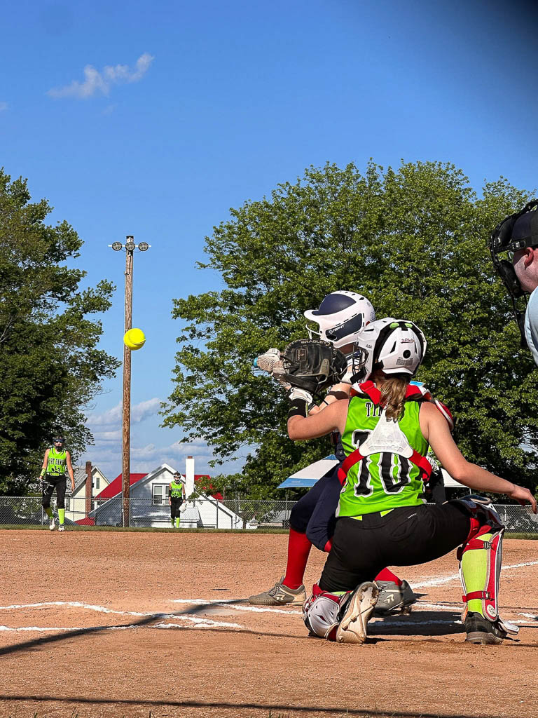 Catcher and batter as ball is about to arrive.