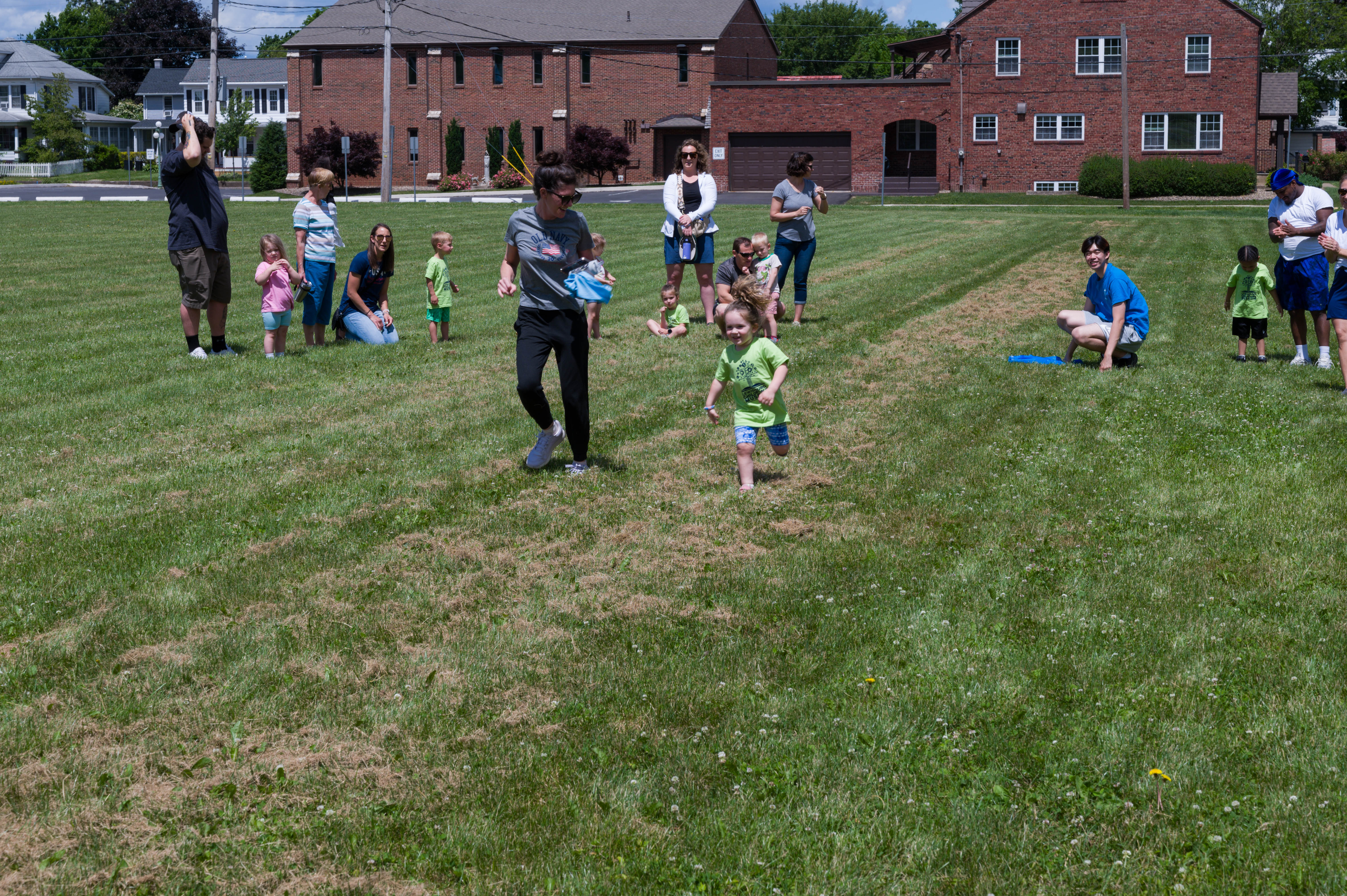 A young girl runs the 20 meter dash.