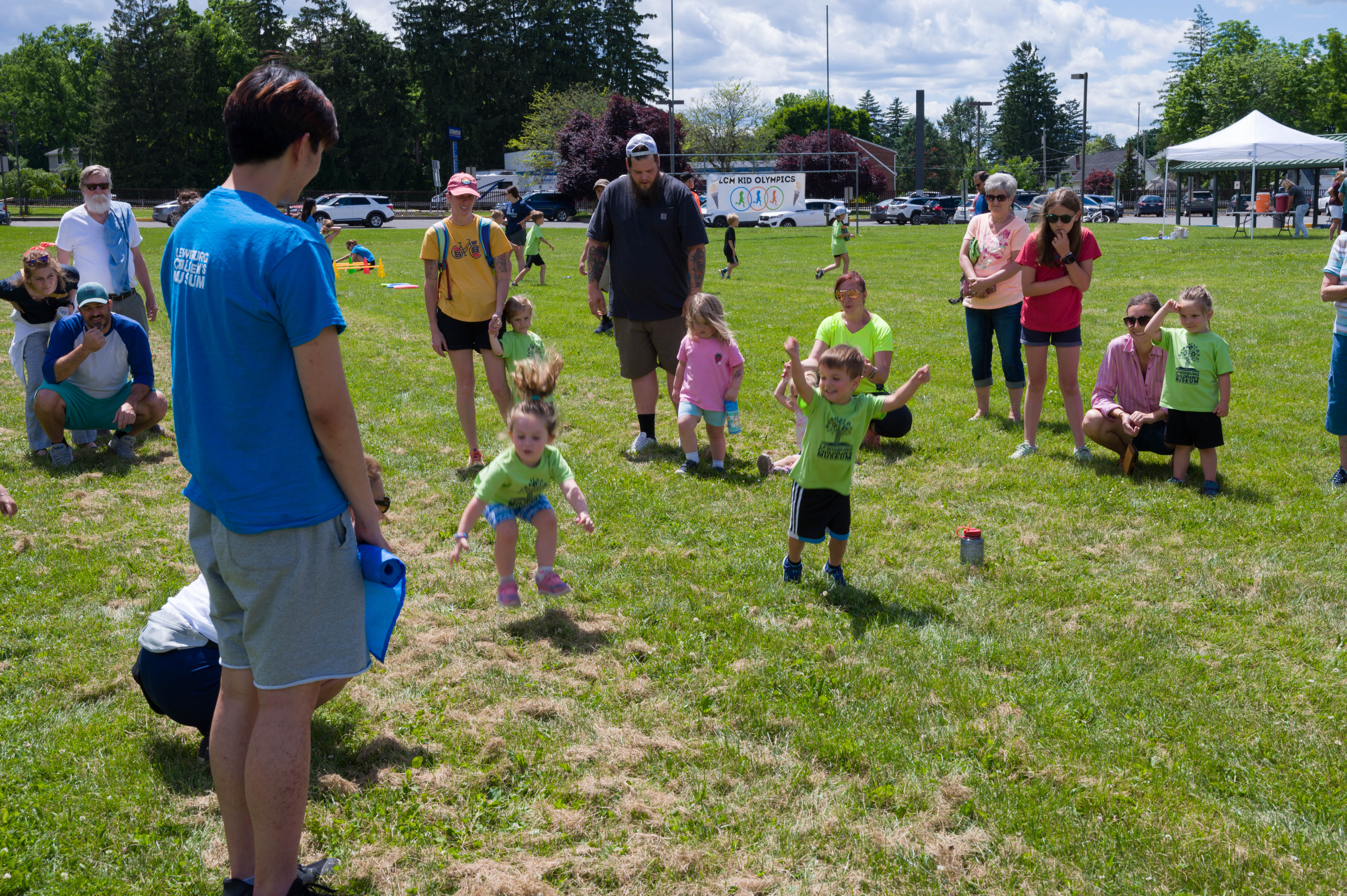 A little girl competes in the long jump.