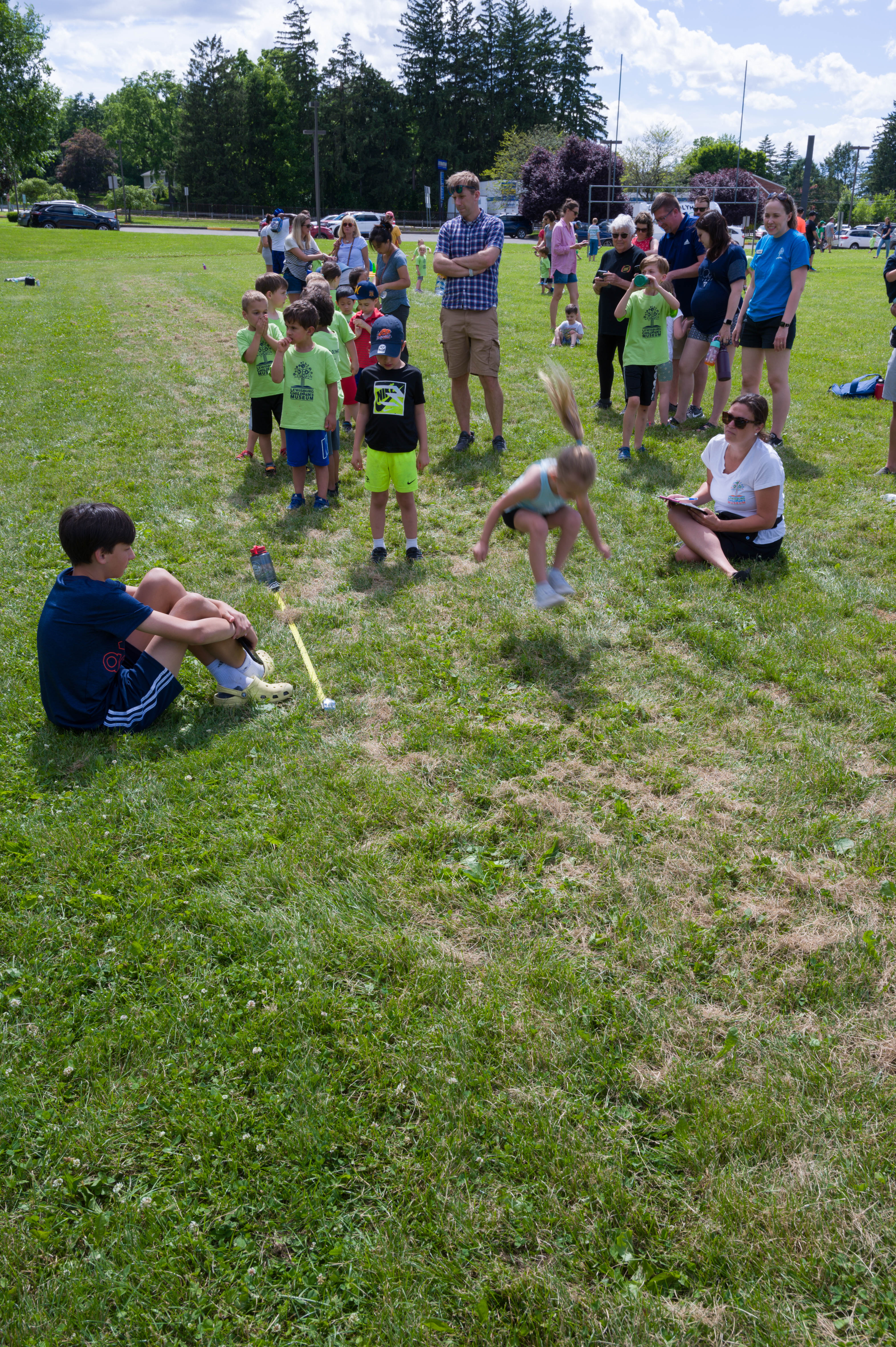 Another girl competes in the long jump.